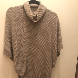 Oversized sweater; neutral color..